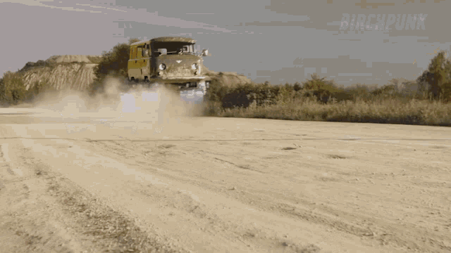 a car is driving on a dirt road with the word dirt in the background