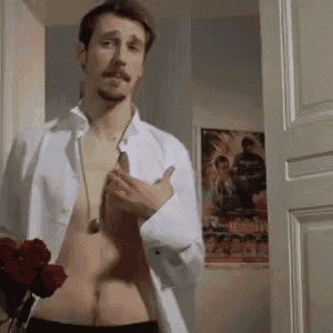 a shirtless man is holding a bouquet of roses in front of a movie poster