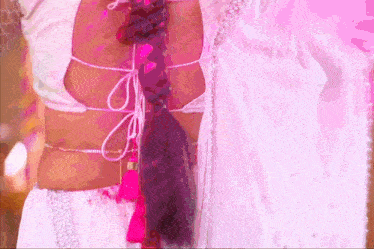 a woman wearing a white blouse with a braided tail