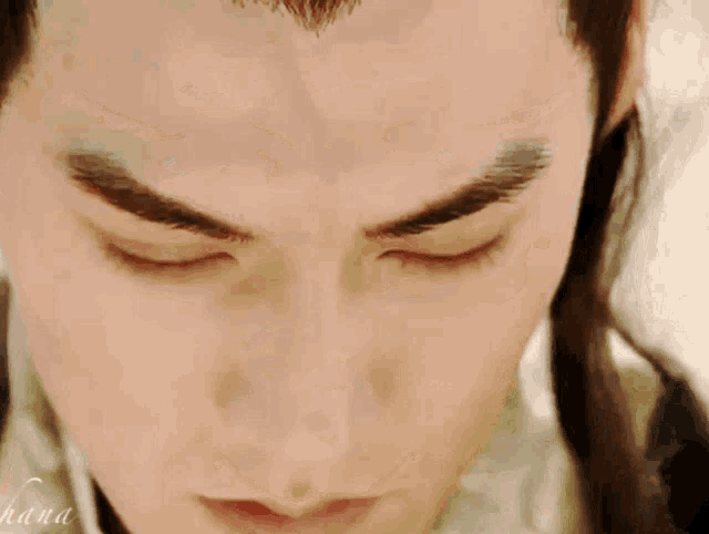 a close up of a man 's face with hana written in the corner