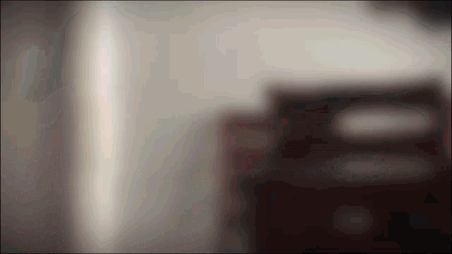 a blurred image of a wall with a few spots of light on it