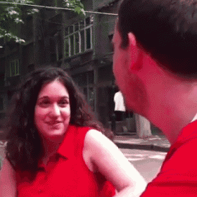 a man in a red shirt is looking at a woman in a red shirt .