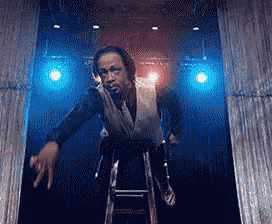 a man standing on a ladder in front of a stage