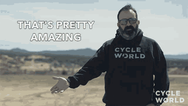 a man with a beard wears a cycle world hoodie