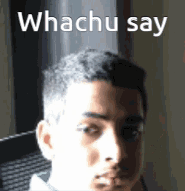 a close up of a man 's face with the words `` whachu say '' written above it .
