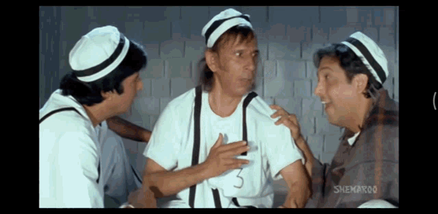 three men are talking in a scene from a shemaroo film