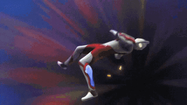 a man in a red and white suit is flying through the air with a blue light behind him