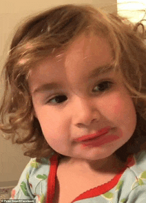 a little girl with lipstick on her face