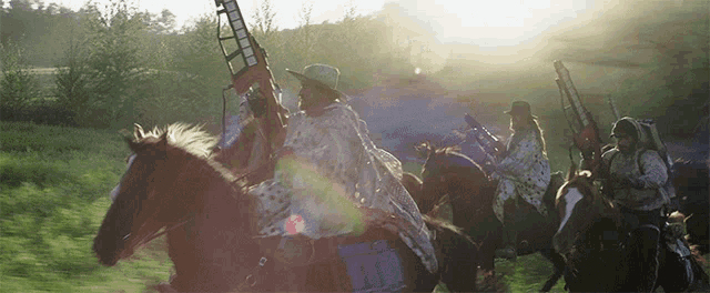 a man in a cowboy hat is riding a horse with the number 11 on the back