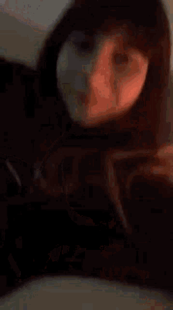 a woman is taking a selfie in a mirror .