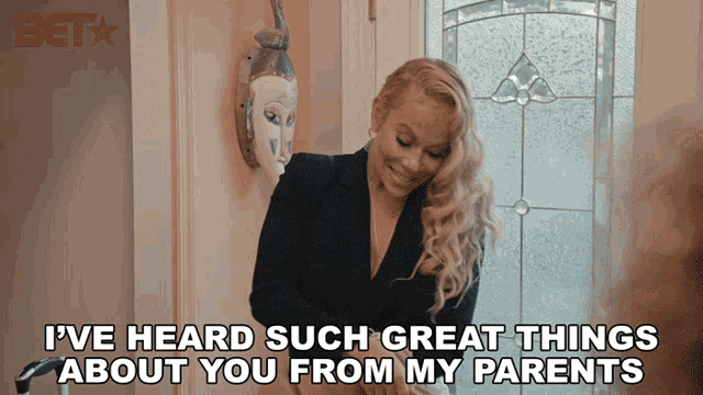 a woman says i 've heard such great things about you from my parents in front of a door