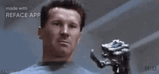 a man is holding a trophy with a robotic hand .