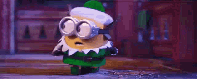 a close up of a cartoon character in a green hat standing in the snow .