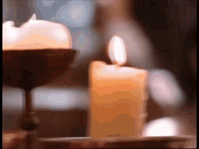 a close up of a lit candle in a candlestick