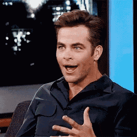 a man in a blue shirt is making a funny face with his mouth open