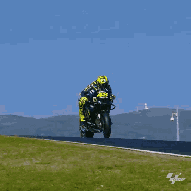 a man riding a motorcycle with the number 46 on the front