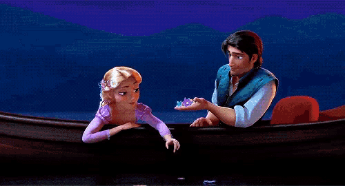 a man and a woman are in a boat and the woman is holding a ring