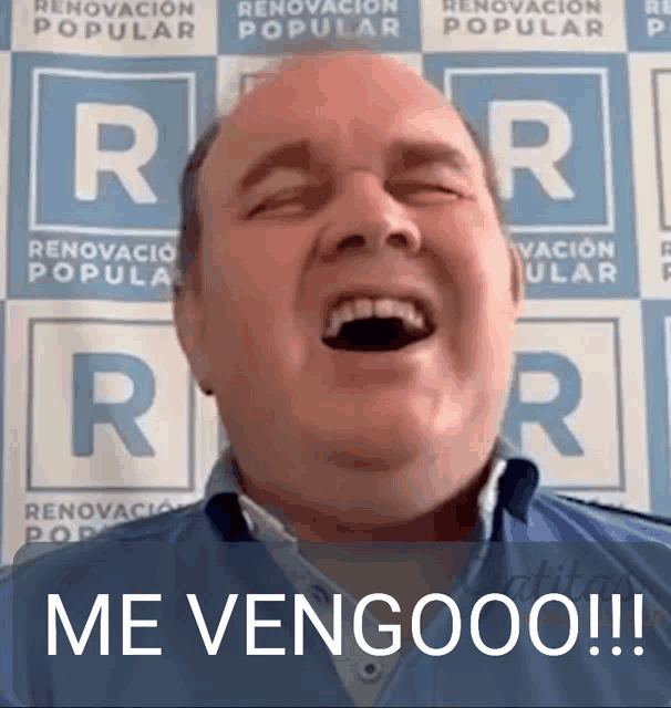 a man is laughing with his mouth open in front of a sign that says rr .