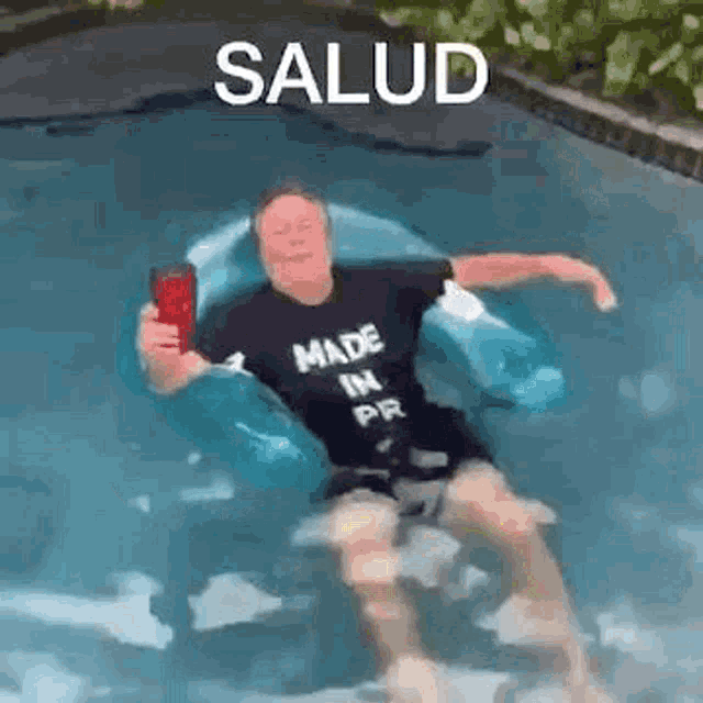 a man is floating on a raft in a pool while holding a cup .