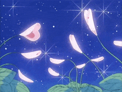 a bunch of pink flowers with hearts on them against a blue sky