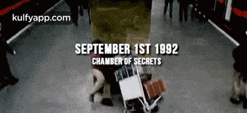 a group of people are standing in a room with a sign that says september 1st 1992 chamber of secrets on it .