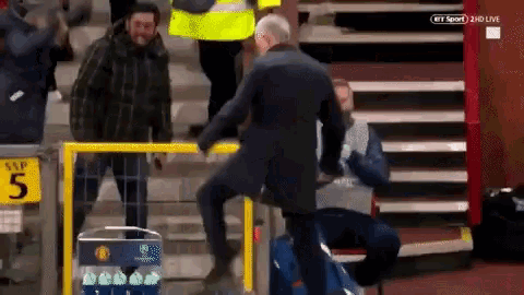 a man climbs a railing in front of a sign that says snp 5
