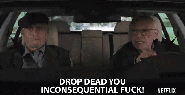 two older men are sitting in a car and one of them is saying drop dead you inconsecutival fuck