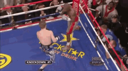 a man in a boxing ring with knockdown # 1 on the corner