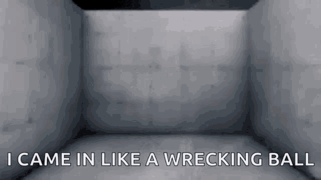 an empty room with the words i came in like a wrecking ball written on the wall .