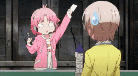 a girl in a pink jacket is holding up a piece of paper in front of a boy in a yellow jacket