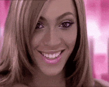 a close up of a woman 's face with pink background