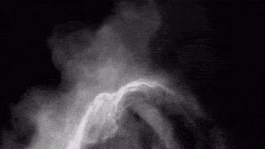 a black and white photo of smoke coming out of a woman 's hair .