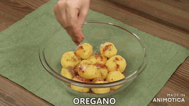 a person is putting potatoes in a glass bowl that says made in animatica on it