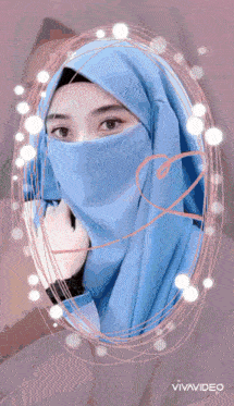 a woman wearing a hijab and a blue scarf with the word official on the bottom