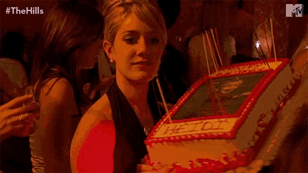 a woman is holding a cake that says happy birthday heidi on it