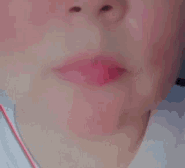 a close up of a person 's mouth with red lipstick on it .
