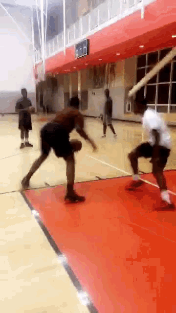 a basketball game is being played in a gym with a sign that says ' basketball '