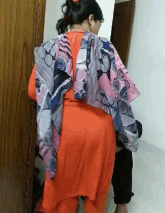 a woman in a red dress with a scarf on her back