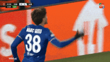 a soccer player wearing a blue jersey with the number 38 on it