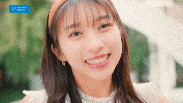 a woman is smiling in front of an up front works logo