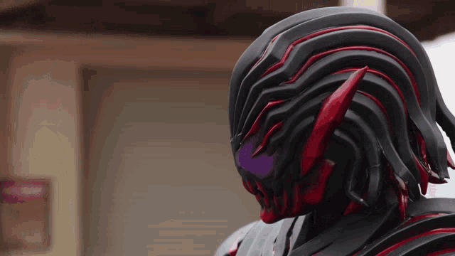 a close up of a person 's face with a black and red helmet