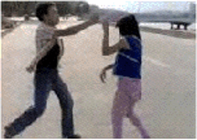 a man and a woman are dancing on the street