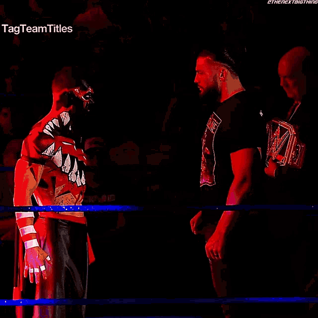 two wrestlers are facing each other in a ring with the tag team titles written on the bottom