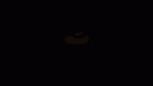 a close up of a girl with green hair in the dark