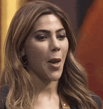 a close up of a woman 's face with her mouth wide open
