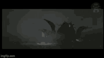 a black and white photo of a dragon flying through the air .