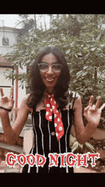 a woman wearing glasses and a red and white polka dot scarf says good night in red letters