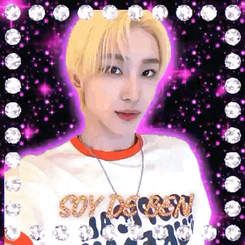 a young man with blonde hair is taking a selfie in front of a purple background surrounded by diamonds .