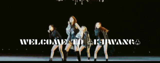 a group of women are dancing in front of a sign that says welcome to khirwang