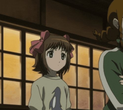 a girl with a pink bow on her head is wearing a shirt with the letter a on it